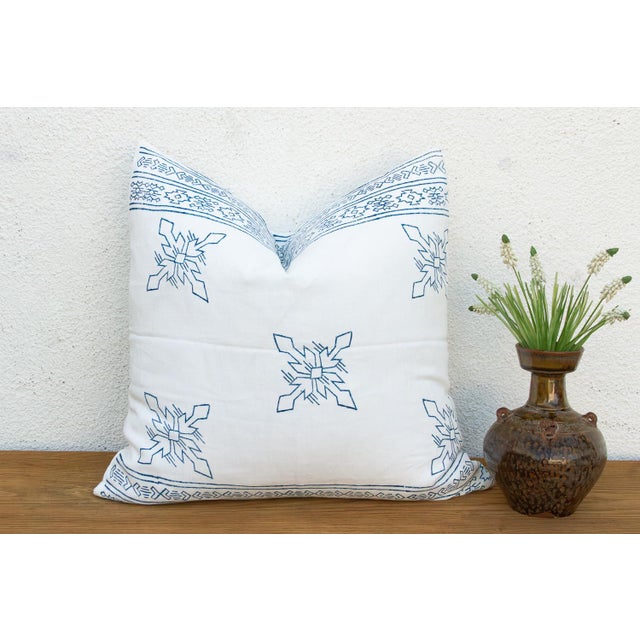 An eight-point star medallion, hand block-printed in jewel blue, sits crisply across a pristine white linen ground on this...