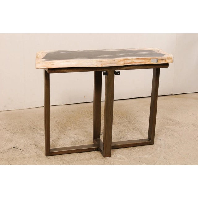 A petrified wood top modernly designed console table. This custom console table has been fashioned from a single thick...