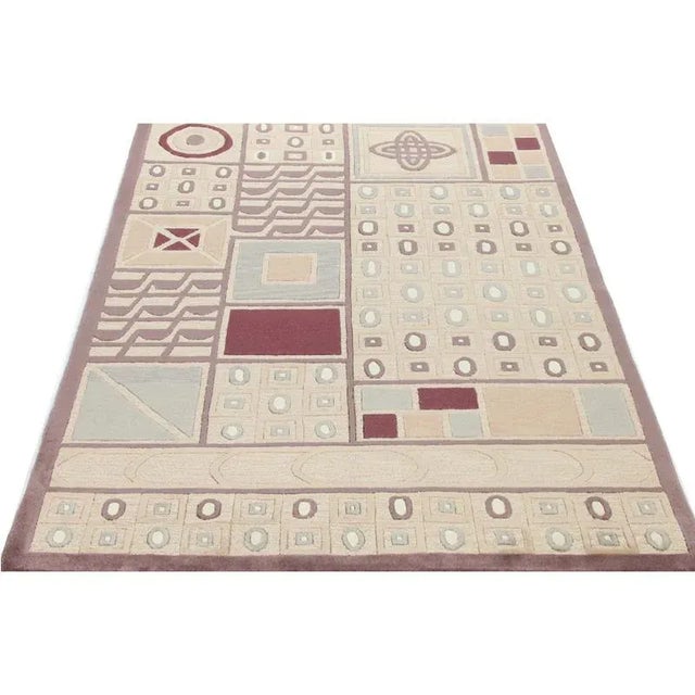 Handwoven Tibetan rug featuring a transitional/contemporary design on a multi-colored field and border accented in shades...