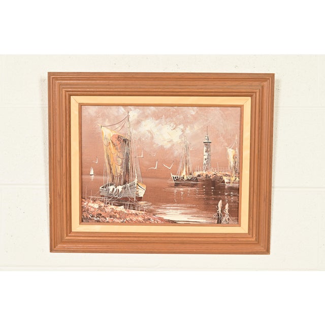 A beautiful original oil painting on canvas seascape scene of ships in harbor in carved wood frame Signed by listed artist...