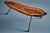 An organic, sculptural coffee table by Carl Auböck, made from a single walnut slab with a rich natural grain and polished...