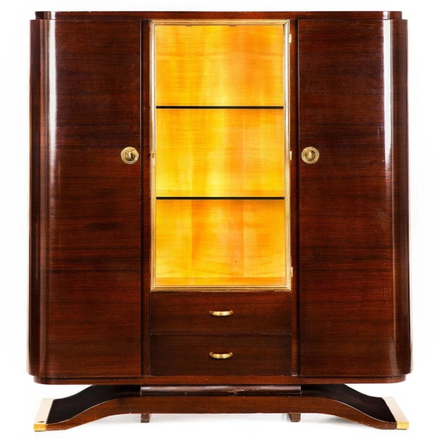 A FINE ART DECO MACASSAR EBONY VITRINE DISPLAY CABINET WITH BLIND-DOOR BOOKCASES Retains original label inside drawer for...