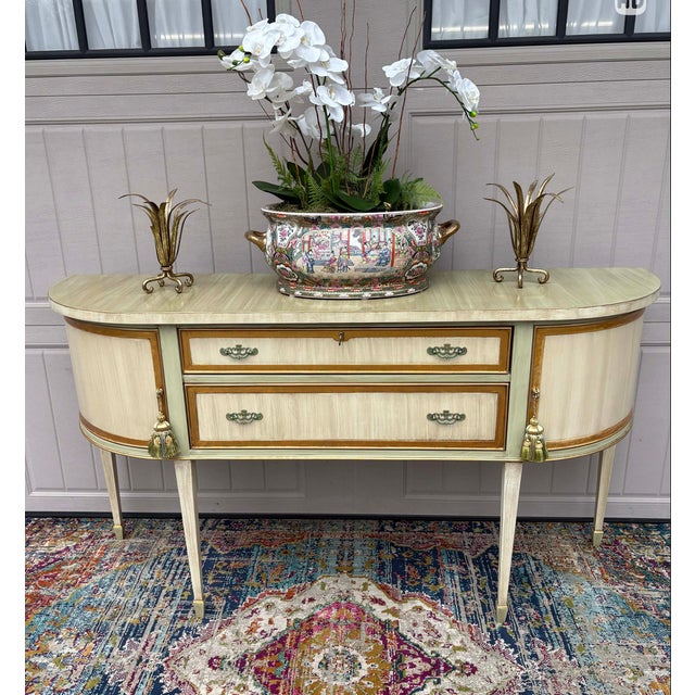 Gorgeous sideboard hand painted in a soft cream and soft sage green with an antiqued finish. Gilded details. This...