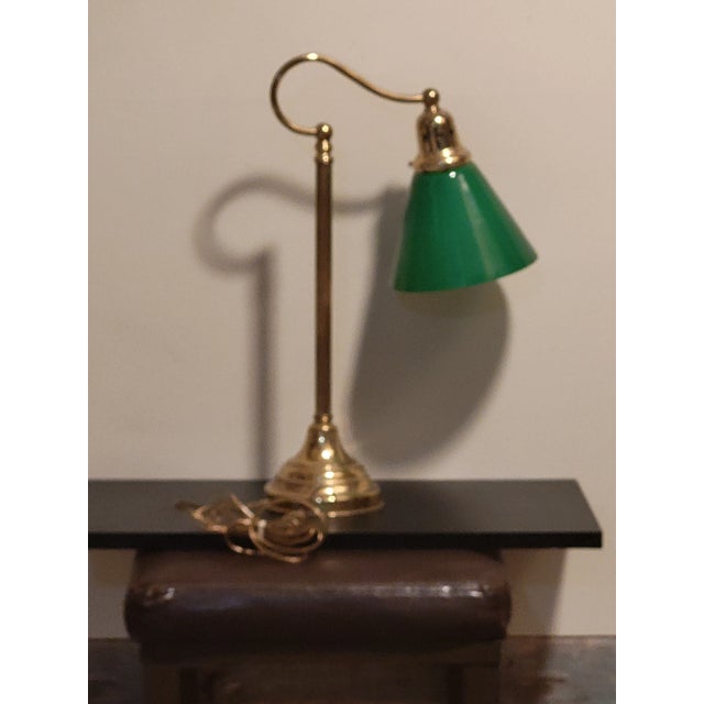 This is a tall and elegant vintage banker’s lamp with the classic green glass shade. The brass base makes it a timeless...