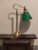 This is a tall and elegant vintage banker’s lamp with the classic green glass shade. The brass base makes it a timeless...