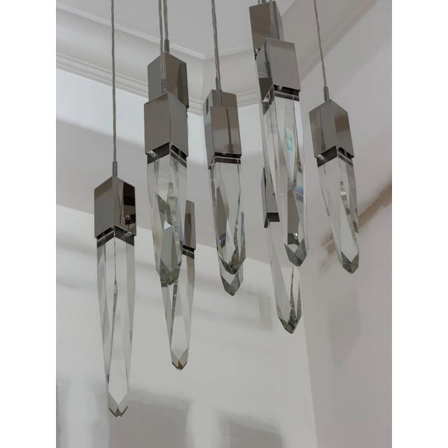 sophisticated architectural lighting installation featuring ten ET2 Quartz pendants in polished chrome with beautifully...