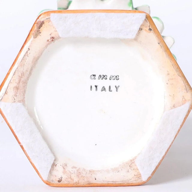 Italian porcelain candlesticks crafted in porcelain and decorated with traditional translucent colors and glazed. Signed...