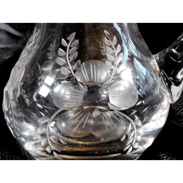 This is a large cut glass pitcher by an unknown company. The bottom is badly scuffed and scratched and I don’t see any...