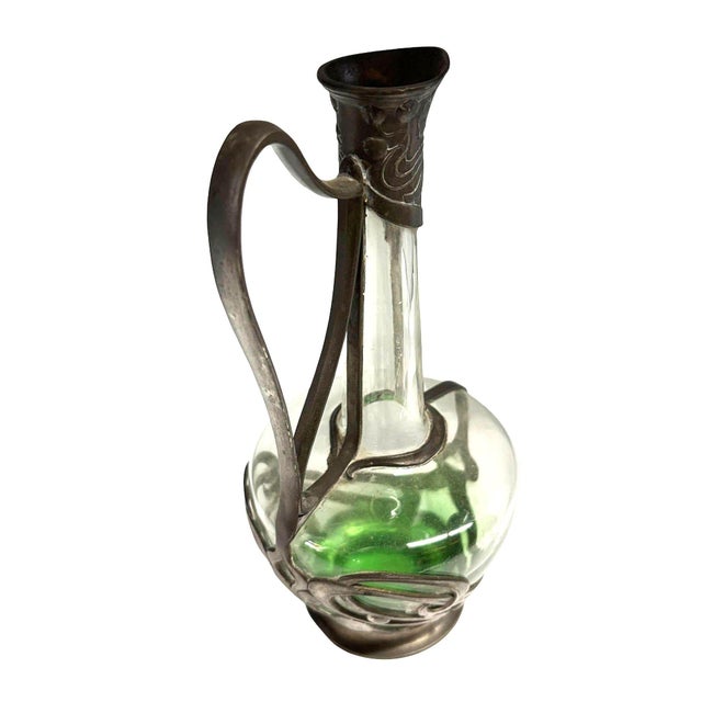 A striking example of early 20th-century Jugendstil design, this elegant Wine Carafe features a vibrant emerald green...