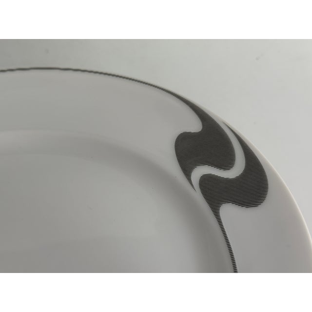 Item: Breakfast plate 20.5 cm Manufacturer: Rosenthal Series: Asimmetria Decoration: Gray grid Material: Porcelain...