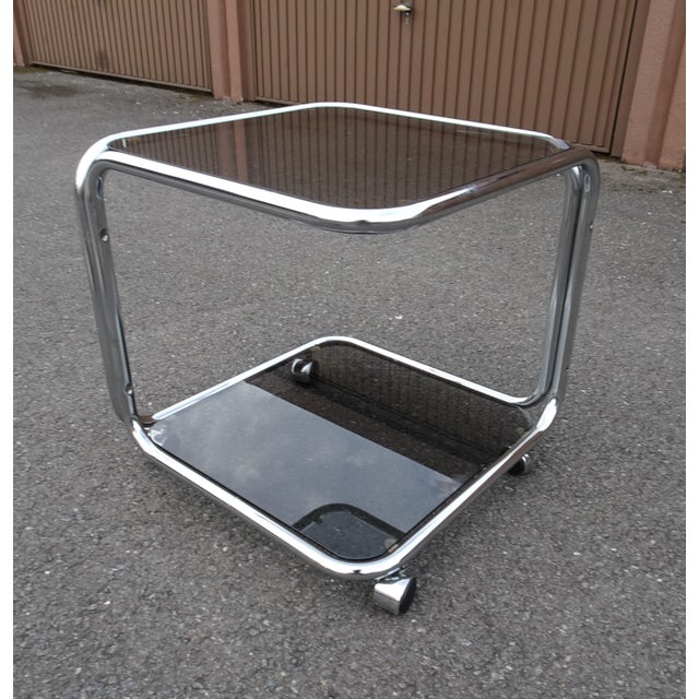 Vintage Italian Chrome and Smoked Glass Rolling Side Table, 1970s, in Good conditions. Designed 1970 to 1979