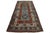 This wool rug showcases a tribal pattern with brown, beige, and red accents on a blue background inspired by Persian...