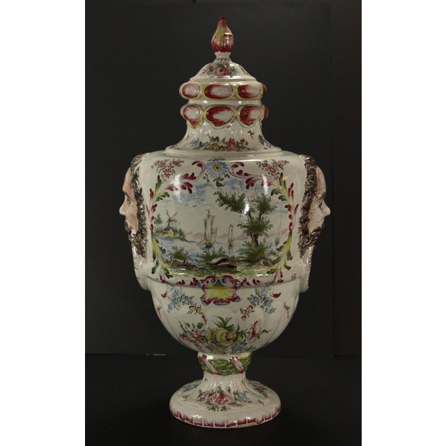 A dramatic large covered urn Impressive earthenware vessel with rich hand painted decoration in vivid colors Two...