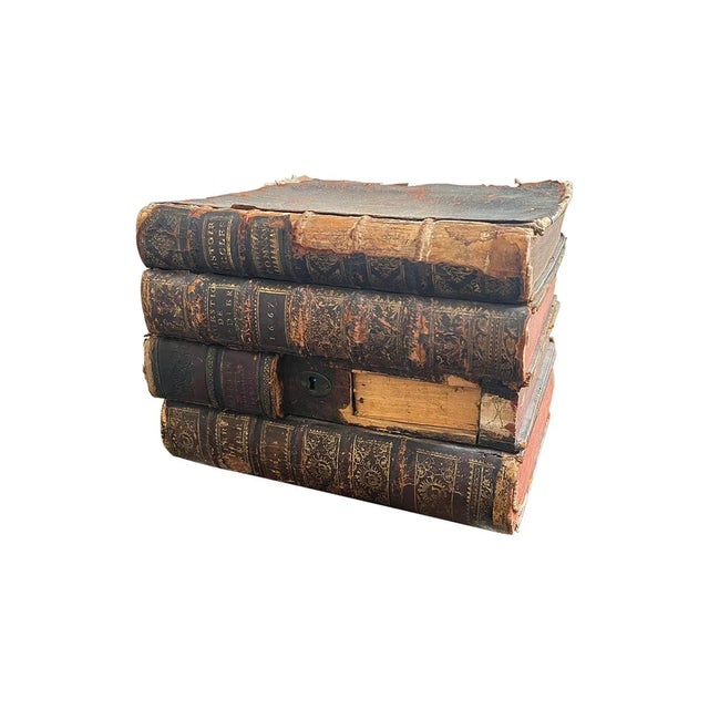 Liquor box, disguised as a stack books (leather over wood). Interior contains compartments for decanters and shot glasses....