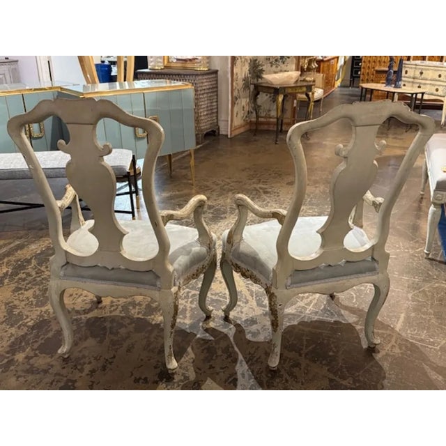 These 19th Century English creme lacquered armchairs with a Chinoiserie design showcase intricate detailing and...