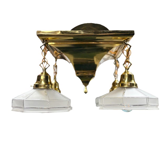 Original fixture from 1910 with a fresh polish to the brass and lacquer to keep it looking so. Four vintage shades with...