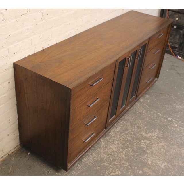 Long mid-century modern American made dresser by Lane Furniture. Strong construction with walnut grain and accenting...