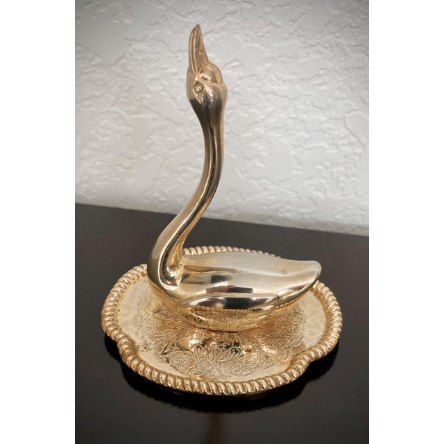 Excellent Pre-Owned Condition. Graceful and diminutive, this lovely-to-look at brass swan on a dish ring holder will keep...