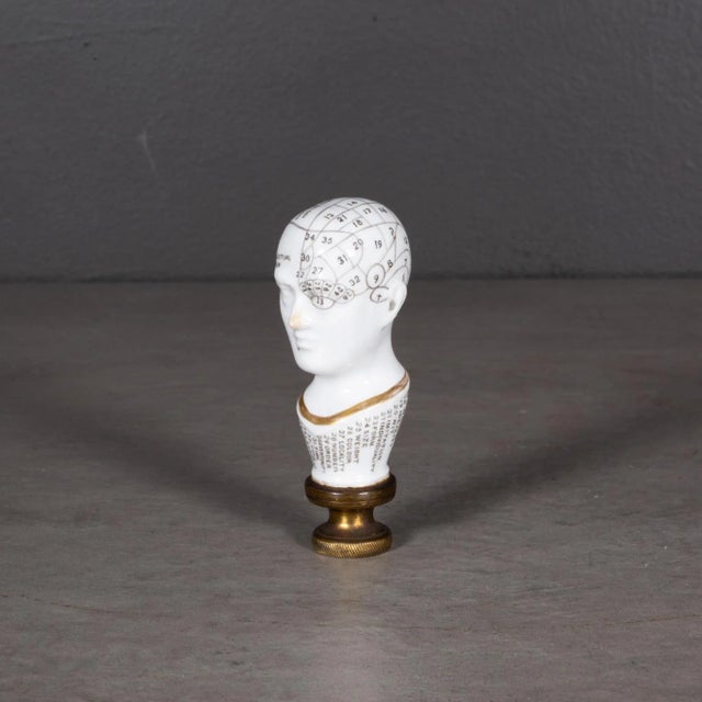 ABOUT ​A 19th-century English porcelain letter seal in the form of a phrenological head. ​The areas of the skull...
