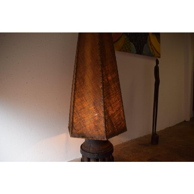 This is a rustic floor lamp from the 1930s. The lamp is a unique, handcrafted piece from that era, made from an old wheel...
