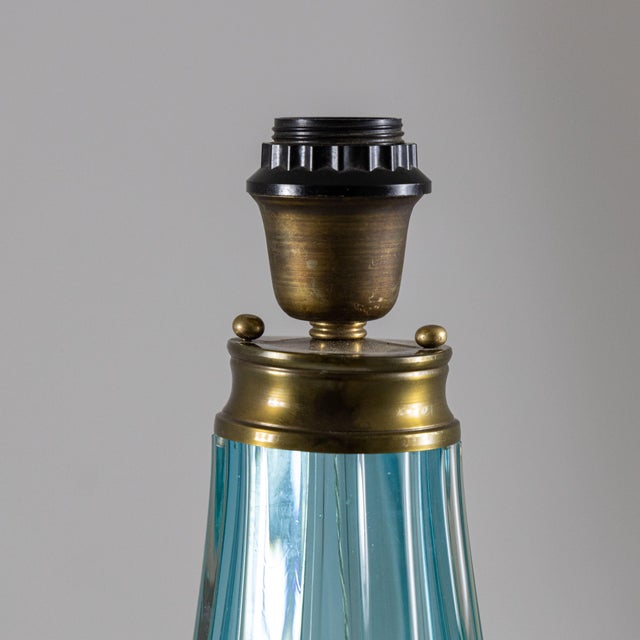 Turquoise glass table lamp, Italian design and manufacture from the 1950s/1960s. The frame is made of glass and metal with...