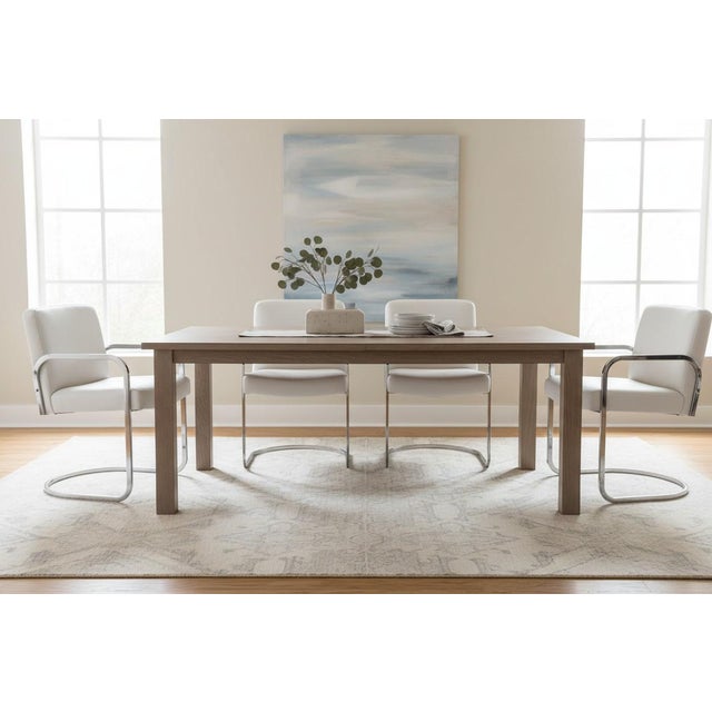 This exceptional set of four Mid-Century Modern cantilever dining chairs beautifully captures the sleek sophistication and...