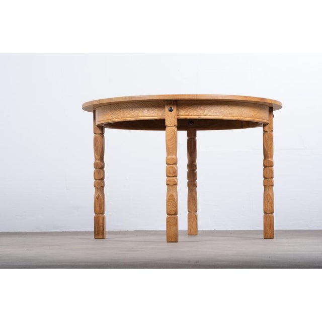 Beautiful Danish brutalist dining table designed by Henning Kjærnulf in the 1960s. Crafted in oak with a striking round...