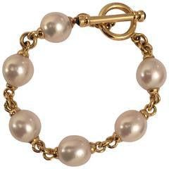 Christina Addison 18kt Yellow Gold and Pearl Bracelet with 6 cultured pearls finished with gold toggle accented with 2...