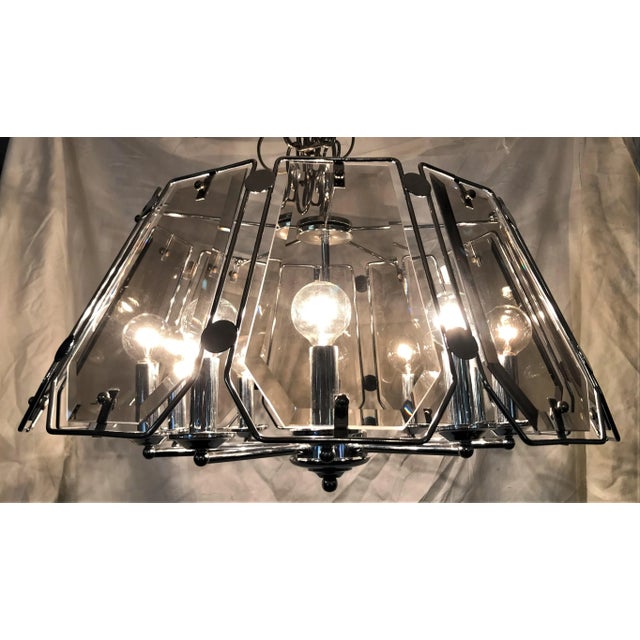 What a cool mid century modern light fixture styled after Fredrick Raymond! This vintage ten light chandelier has ten...