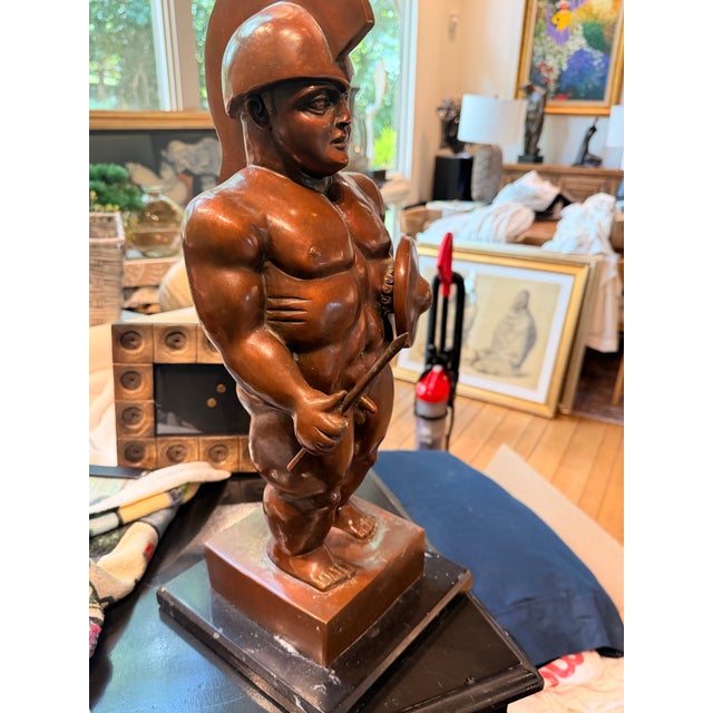 Inspired by the iconic sculptural style of Fernando Botero, this impressive after Botero bronze-patina sculpture depicts a...
