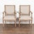 Pair, Swedish white painted armchairs with carved details along edges, top of back and bottom of seat; turned fluted legs....