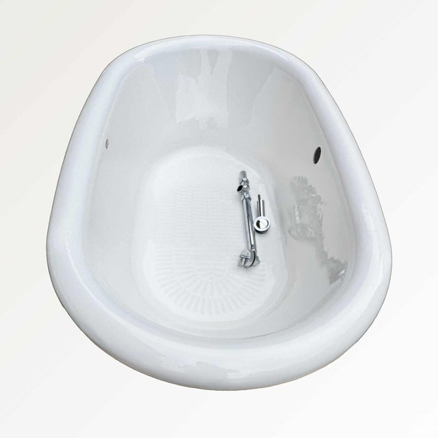 Kohler cast iron enameled soaking tub complete with faucet and all parts. Glazed terracotta sectional base covers. Center...