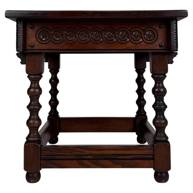 A charming early 20th-century English side table, finely crafted from oak and distinguished by its compact proportions,...