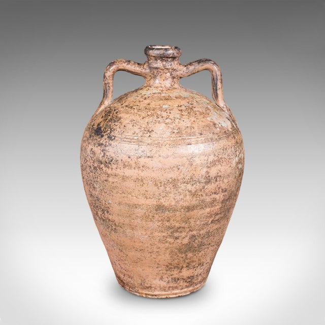 This is an antique weathered veranda amphora. An English, terracotta ornamental garden accent in Italianate taste, dating...