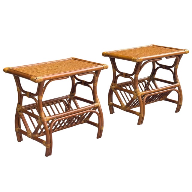 A pair of vintage rattan end tables featuring a woven top, sculptural bent rattan frame, and integrated magazine rack....