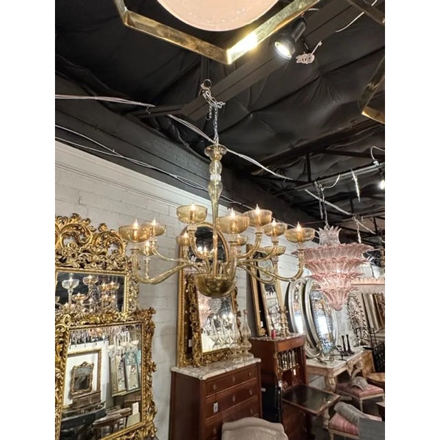 Gorgeous Murano tabaco glass 12 arm chandelier with rostri elements. The chandelier has been professionally rewired, comes...