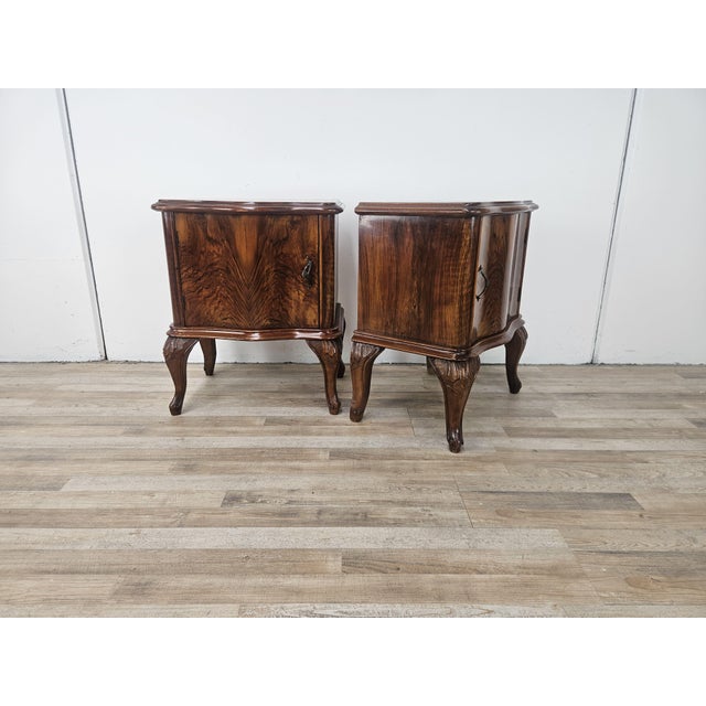 1950s Chippendale-style nightstands, distinctive for their slightly wavy lines and the carvings decorating the legs and...