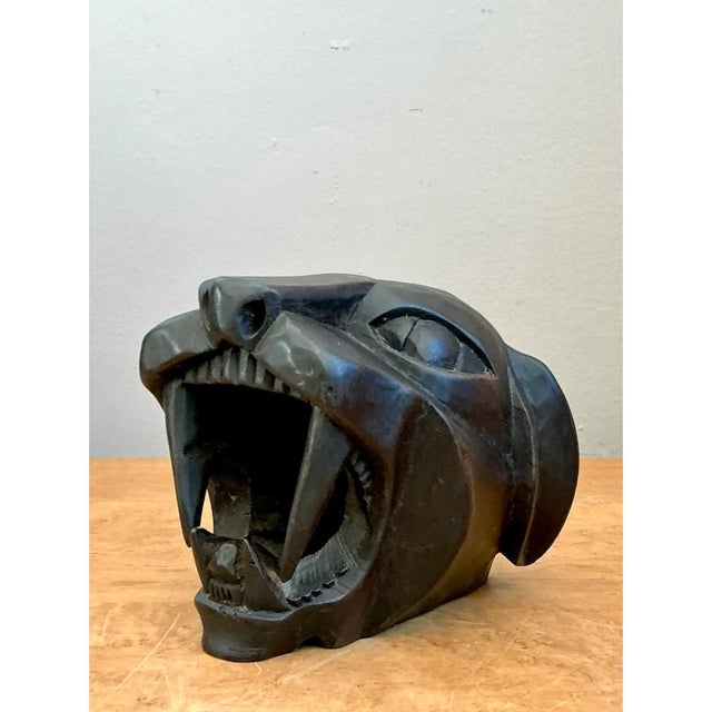 This sculptural head captures a panther mid-roar, its jaws thrown wide open to reveal a dramatic array of carved teeth,...