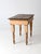 This antique primitive farmhouse table features a plank wood top and gracefully turned legs. The peachy cream finish...