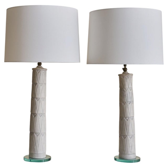 A tall Italian ceramic and glass table lamp, dating to the mid-20th century. The elongated ivory ceramic base is...