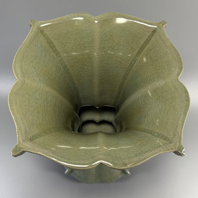 Classic Chinese celadon porcelain Gu‑shape archaic vase, featuring flared notched rim, segmented body and flared base. It...