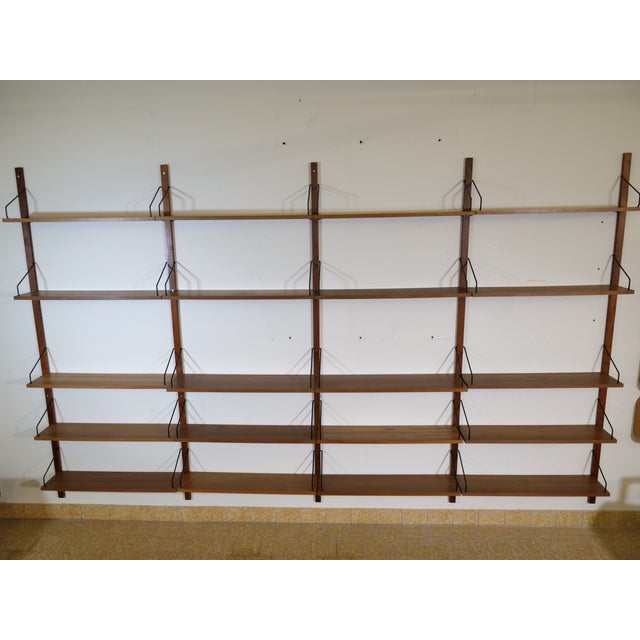 Modular mid-century shelving system, model Royal, in teak by Poul Cadovius, 1960s. The set comprises 25 pieces, including...