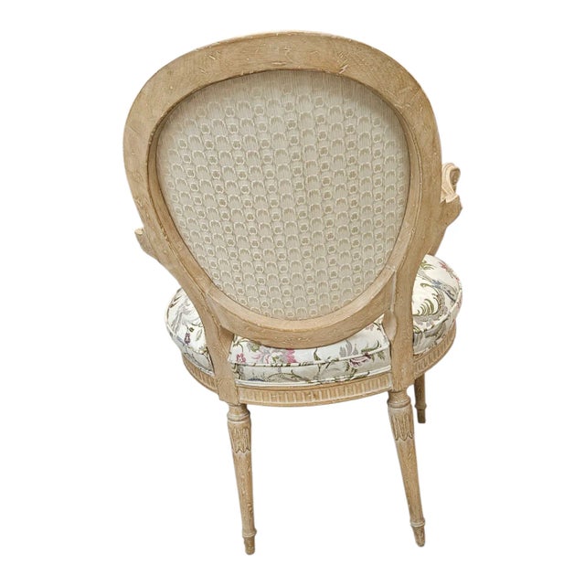 A lovely French style bergere with a foral fabric. And nicely carved blonde wood.