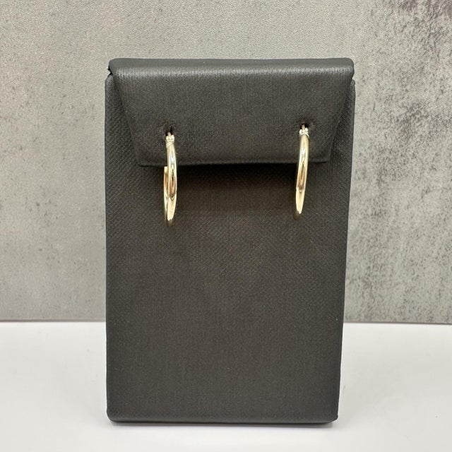 These tube hoop earrings are crafted in 14kt yellow gold and feature a smooth polished finish. With a 19.9mm outer...