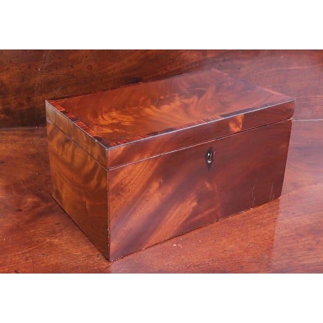 A fine Georgian tea caddy. Two compartments internally with original lids Tropical hardwood with cross banding to the top...