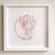 The artwork features a nude figure in a seated pose, gracefully arching her back against a backdrop of soft, pink foliage....