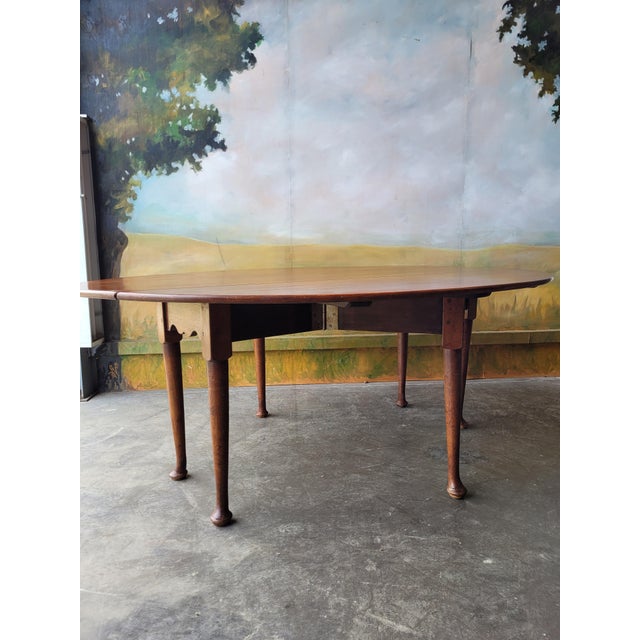 Amazing oval table in solid oak from the 19TH CENTURY. Once folded, it can be stored along a wall like a console. Composed...