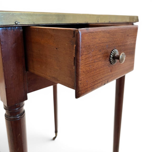 An elegant 18th-century French Louis XVI rafraîchissoir table crafted from finely figured walnut, featuring a distinctive...