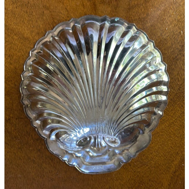 Vintage silver-plate dish is molded in form of a classic scallop shell. Back is stamped silver-plate with letter S of...