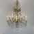 A Genoese twelve-light gilded Empire chandelier, composed of a turned, carved, and gilded wooden shaft and twelve gilded...